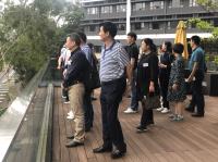 The delegation gazing into distance from the Lanson Terrace in the College